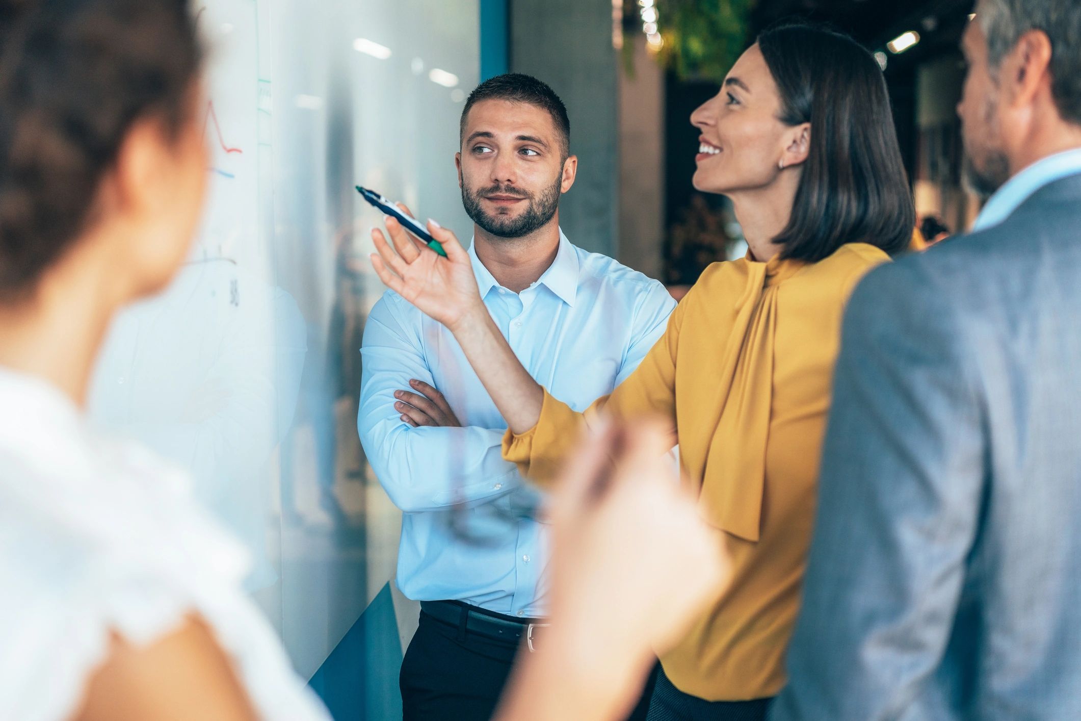 Business team planning strategy at a whiteboard